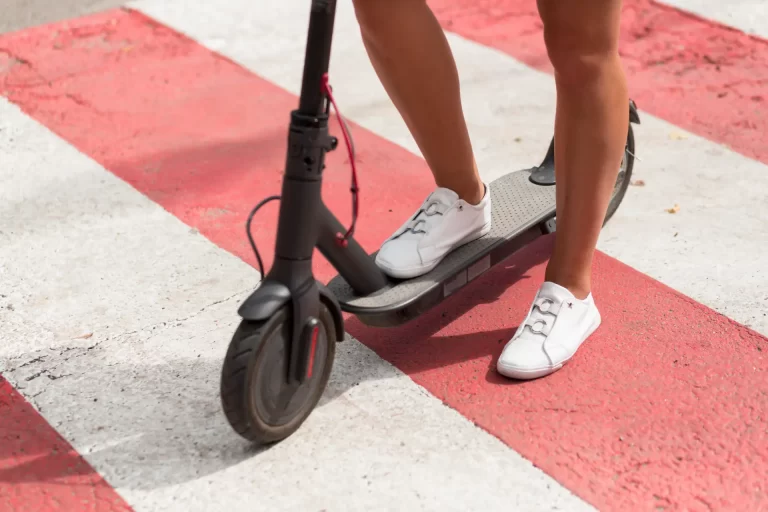 woman-with-tennis-shoes-riding-scooter