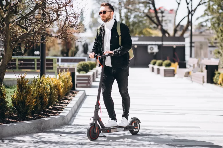 young-handsome-man-riding-scooter-park